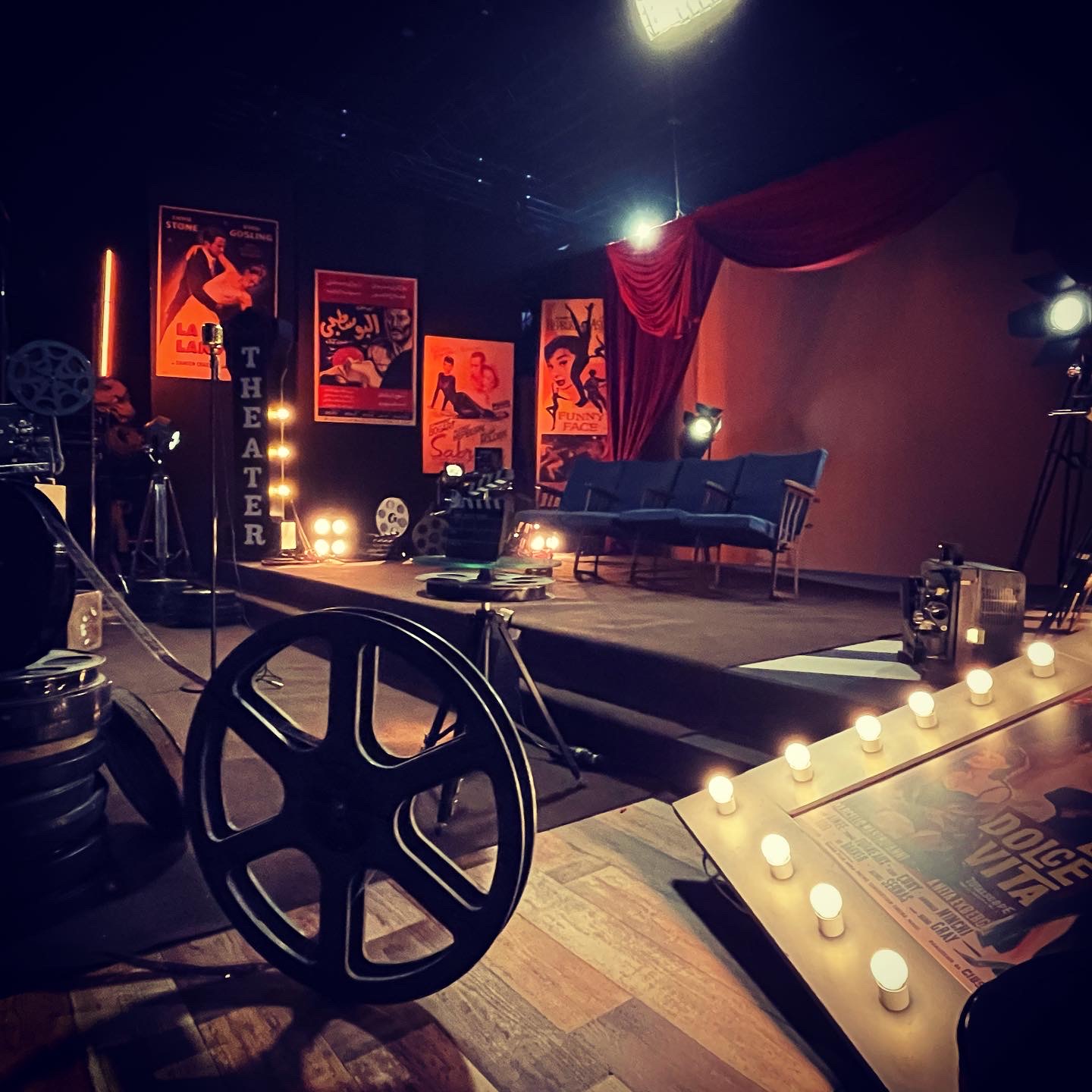 A theater set with film reels, production design by Maze of Tales